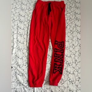 Red pink VS jogger pants. Has small 3 black marks. In good condition